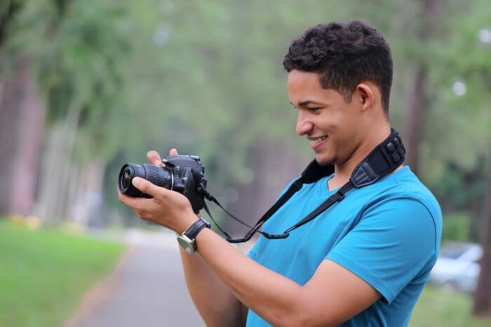 A guy holding Nikon D3400 Camera