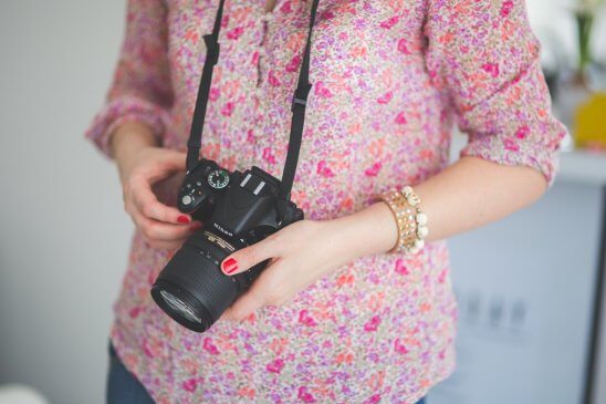 Woman photographer holding Nikon Camera