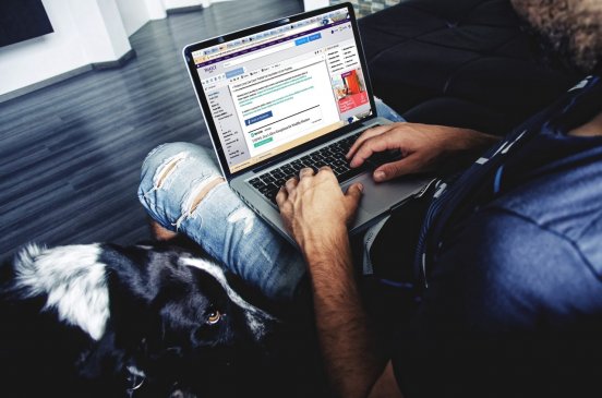 Man is working on his laptop through Internet
