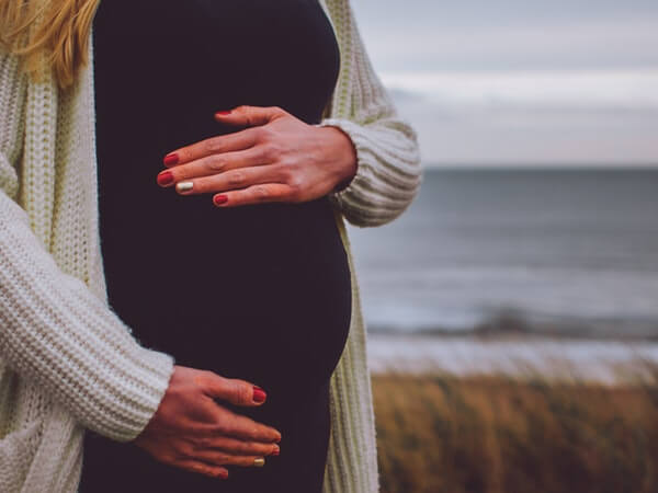 Pregnancy woman standing near beach