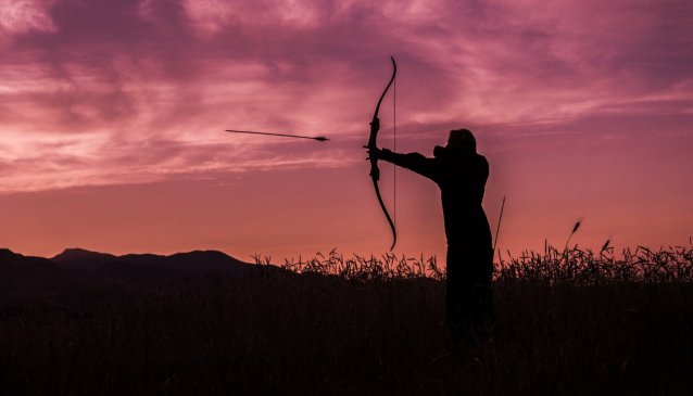 Person holding an arrow for hunting