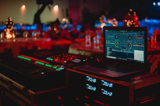 black-laptop-beside-audio-mixer-set