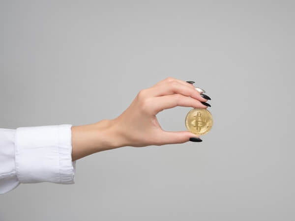 Woman holding bitcoin