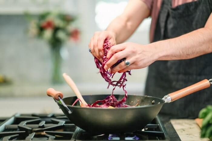 person-cooking-red-cabbage