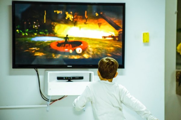 Boy standing infront of LED TV