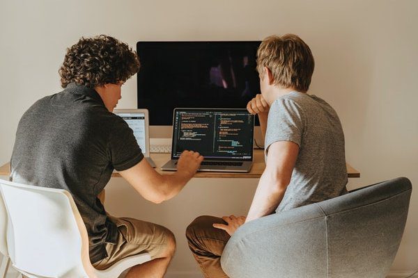 Two men looking at laptop